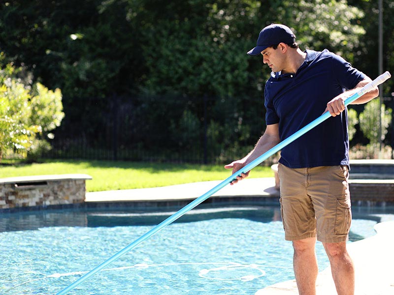 Repairman, cleaning service man at home swimming pool